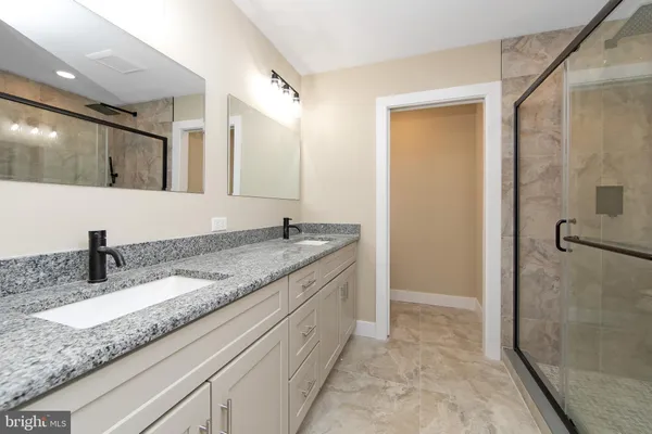 a view of a big room with a ceiling fan and windows