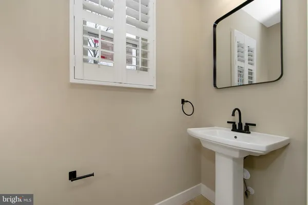 a large kitchen with a large counter top stainless steel appliances and cabinets