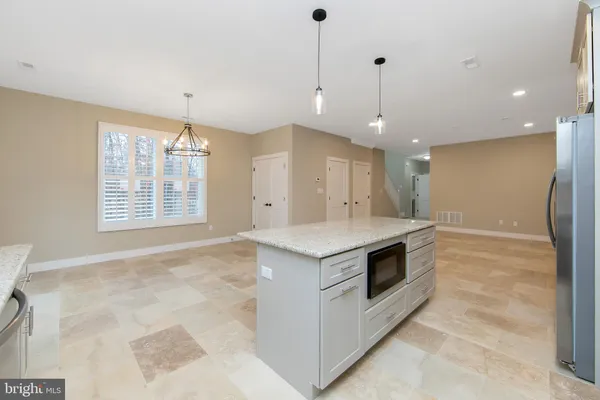 a kitchen with a stove and a refrigerator