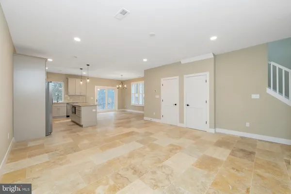 a kitchen with granite countertop cabinets stainless steel appliances and a counter space