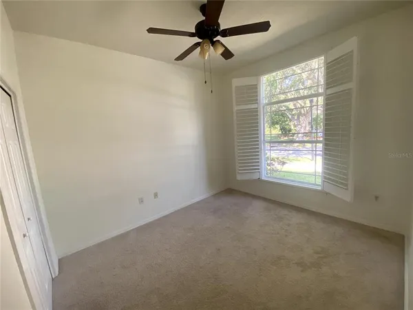a view of a livingroom with a window and a ceiling fan
