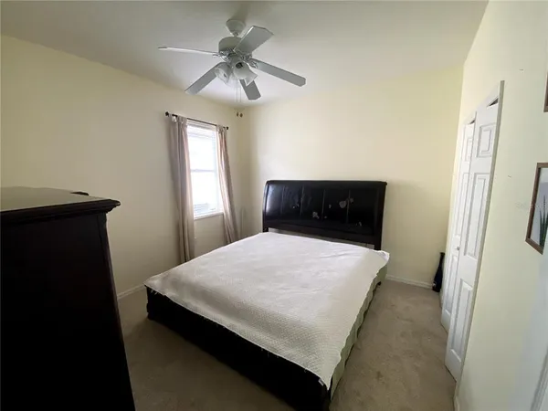 a bedroom with a bed and a dresser