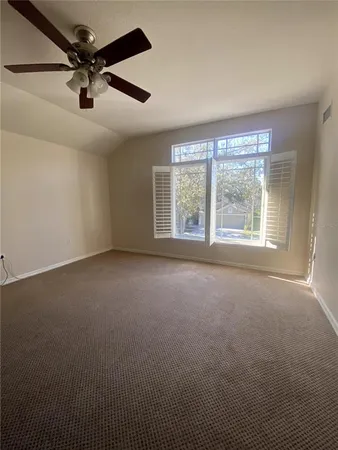 a view of a livingroom with a ceiling fan and window