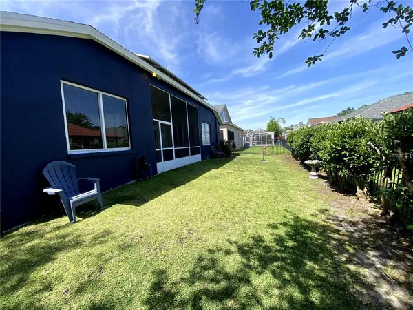a view of a backyard with table and chairs and potted plants