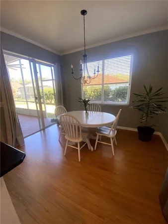 a dining room with furniture window and wooden floor