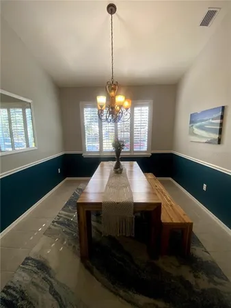 a view of a dining room with furniture and window