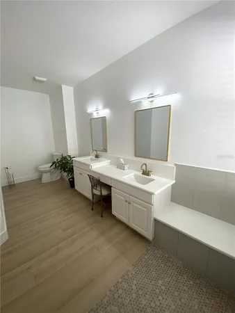 a bathroom with a double vanity sink and a mirror