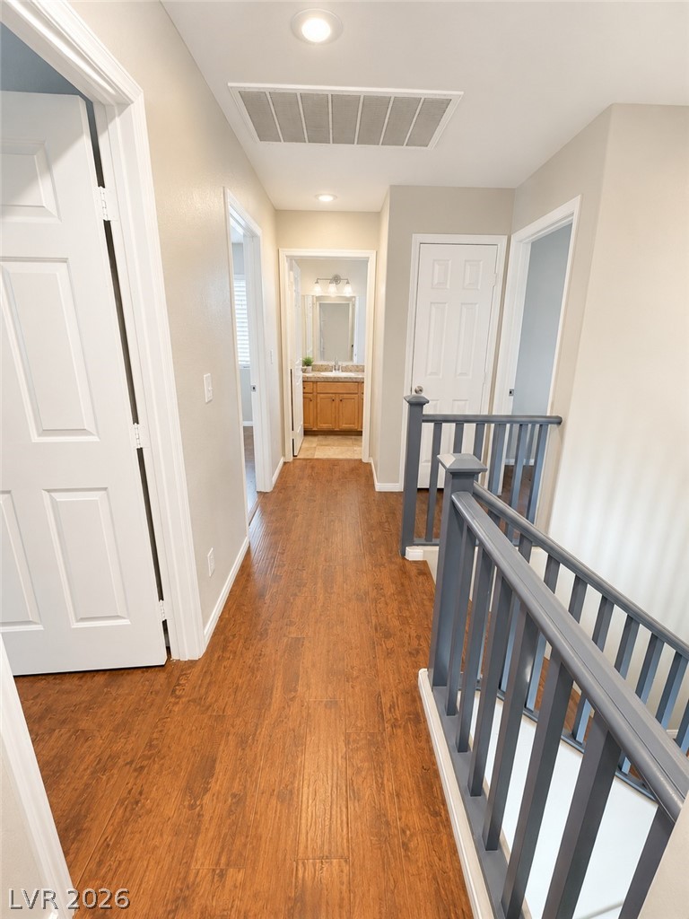 7213 London Bridge Avenue Las Vegas, NV 89130 - Photo 5 of 11 This bright hallway showcases durable flooring and offers a glimpse into a well-appointed bathroom.