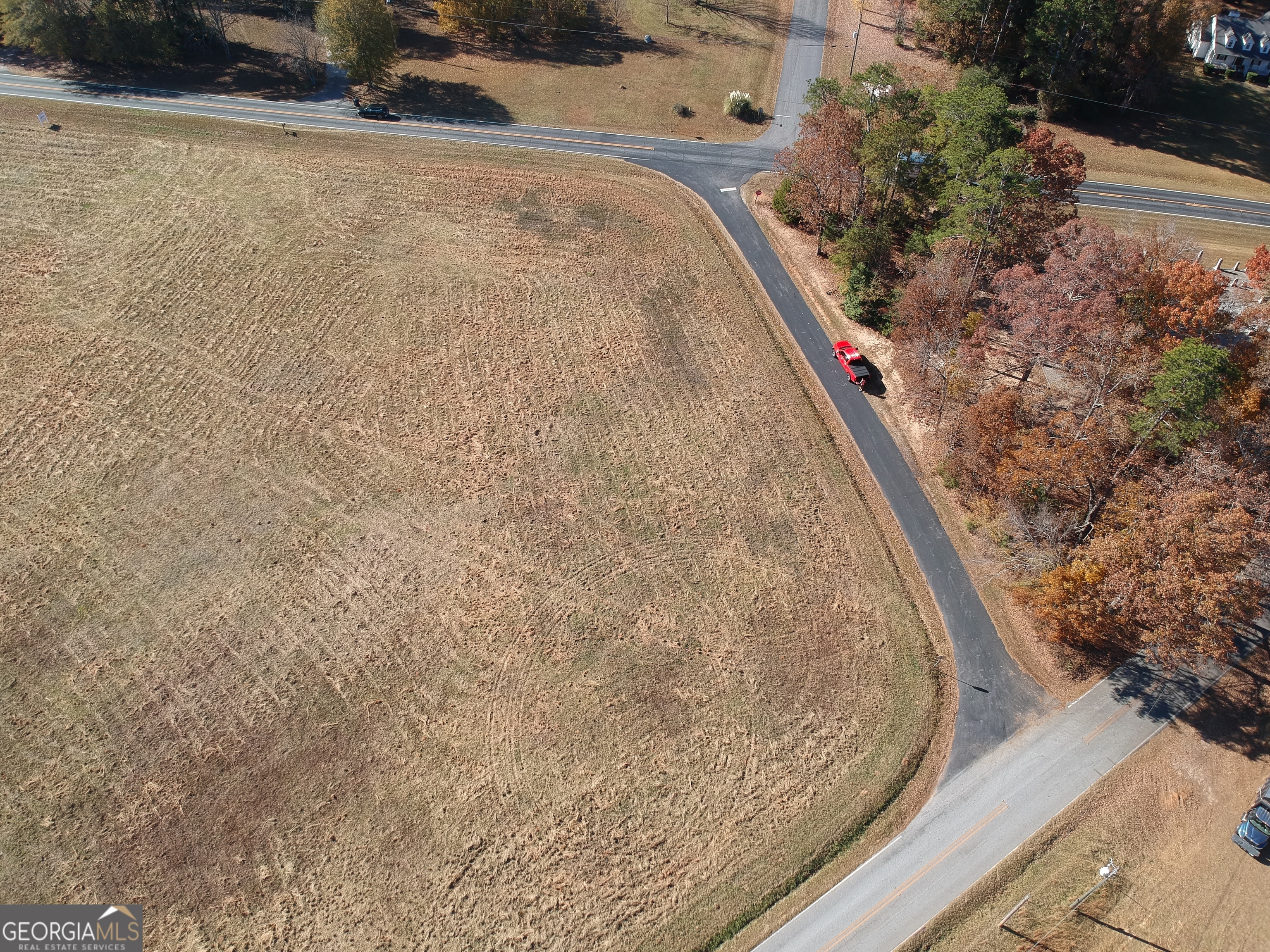 0 Adams Road, Unit TRACT 4 Covington, GA 30014 - Photo 2 of 5 a view of a dry yard with plants and wooden fence