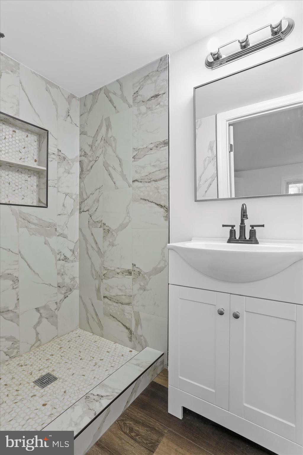 6906 Mariah Furnace Road Boonsboro, MD 21713 - Photo 11 of 38 a bathroom with a sink a mirror and shower