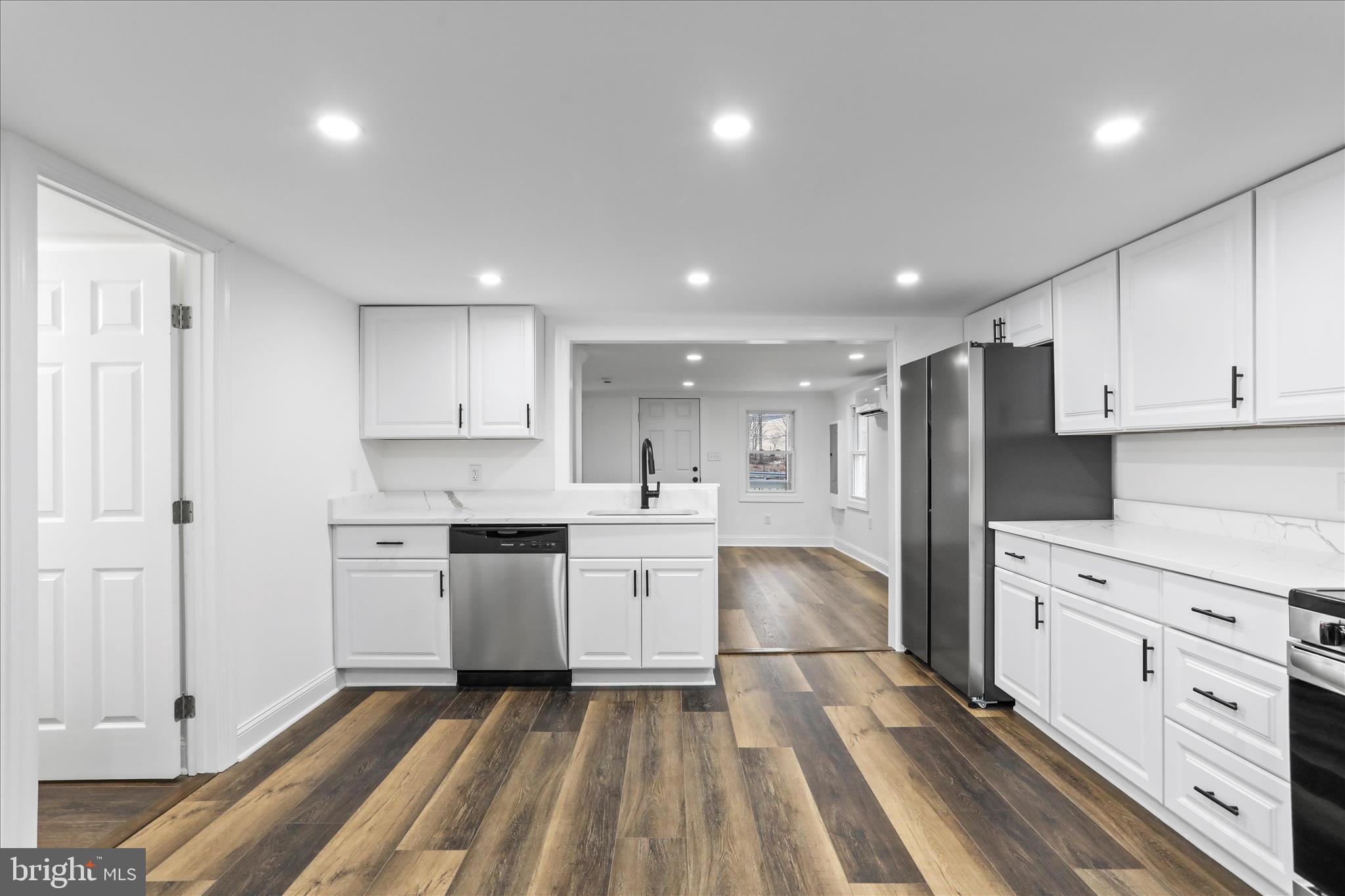 6906 Mariah Furnace Road Boonsboro, MD 21713 - Photo 14 of 38 a large white kitchen with stainless steel appliances granite countertop a stove and a sink