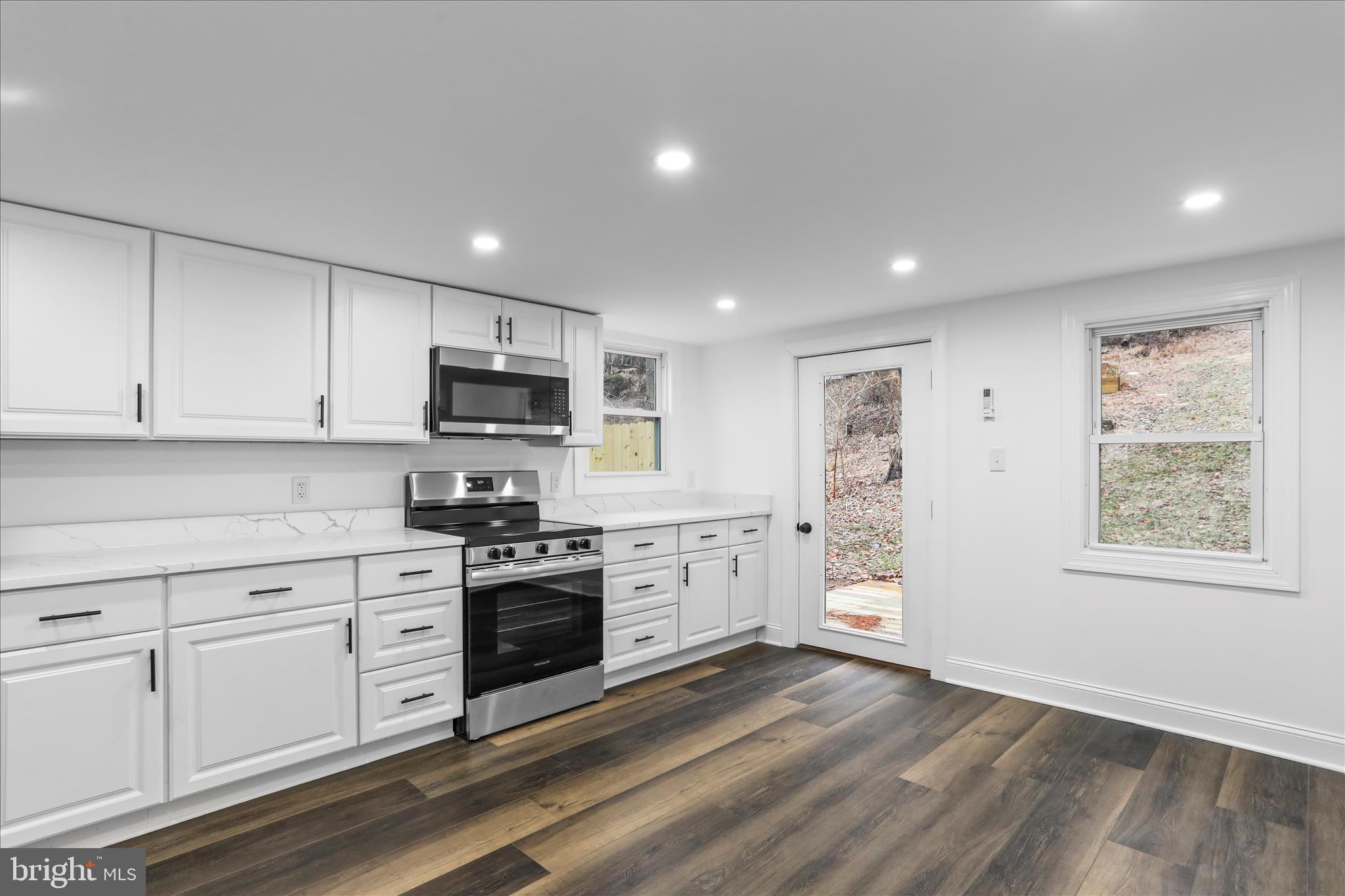 6906 Mariah Furnace Road Boonsboro, MD 21713 - Photo 16 of 38 a kitchen with granite countertop white cabinets and stainless steel appliances