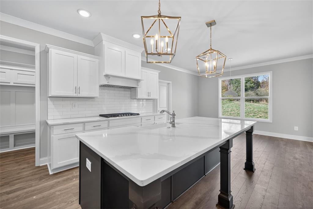 8845 Jot Em Down Road Gainesville, GA 30506 - Photo 19 of 87 a kitchen with stainless steel appliances a table chairs and wooden floor