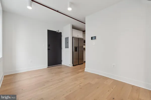 a view of hallway with wooden floor