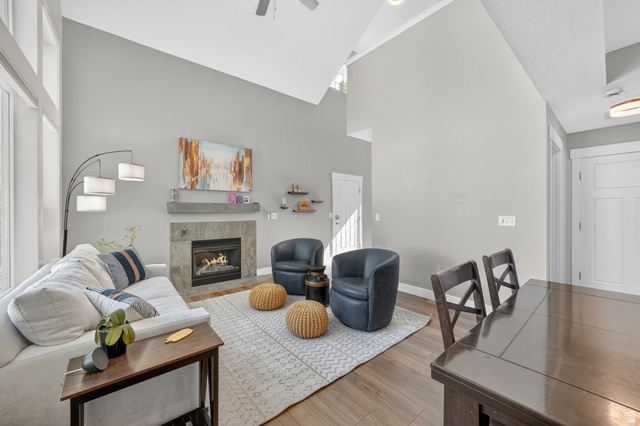 7872 Farm House Lane Midvale, UT 84047 - Photo 7 of 39 Spacious living area featuring a vaulted ceiling and wood-finish flooring