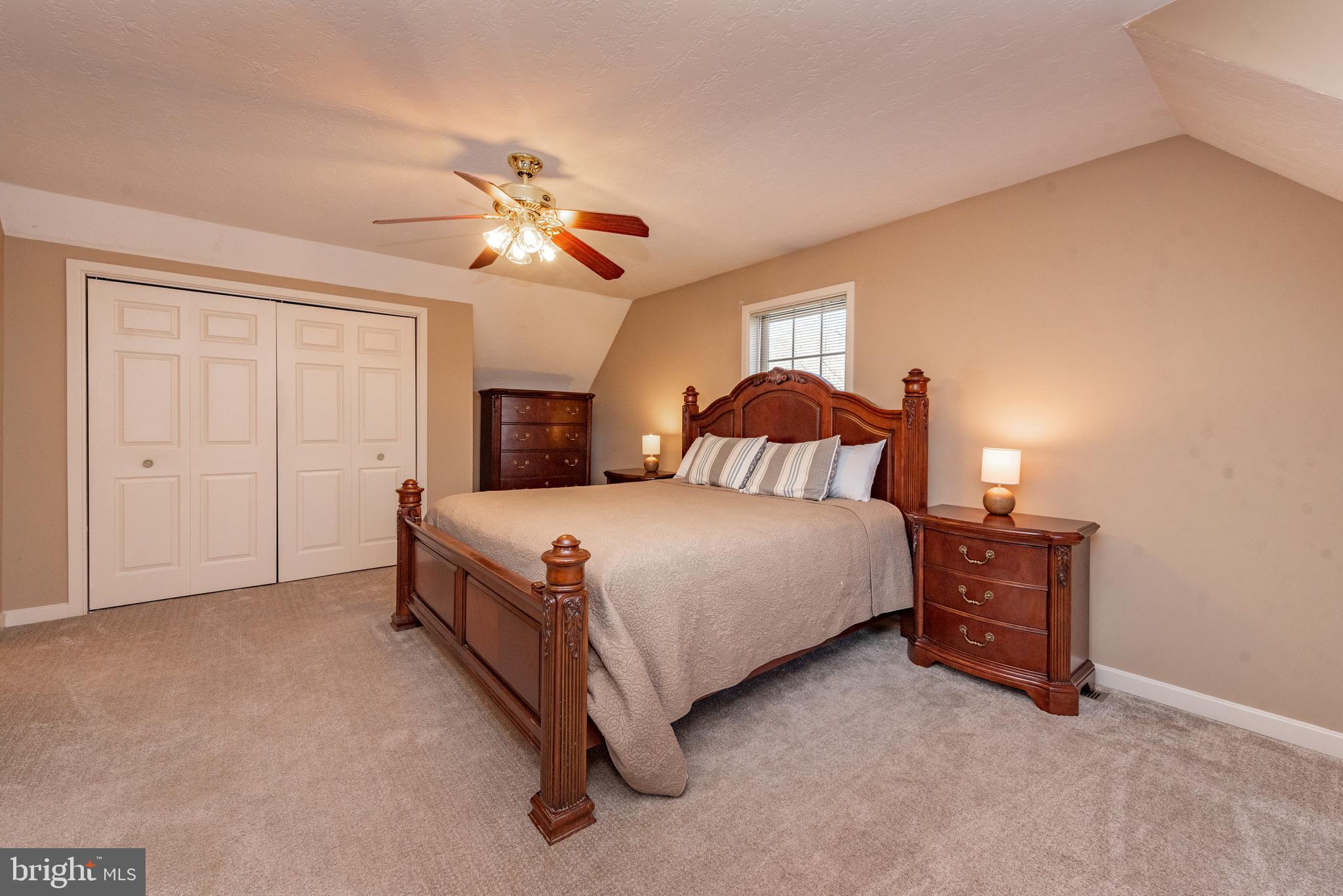 2828 Glendale Road Swanton, MD 21561 - Photo 29 of 78 a spacious bedroom with a bed and a chandelier