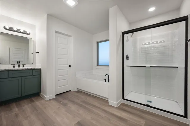 a bathroom with a tub sink and mirror