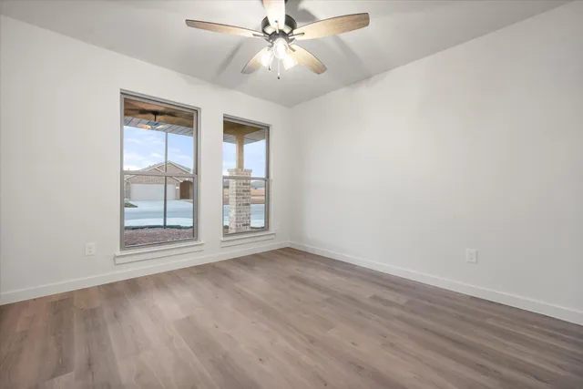 wooden floor in an empty room with a window