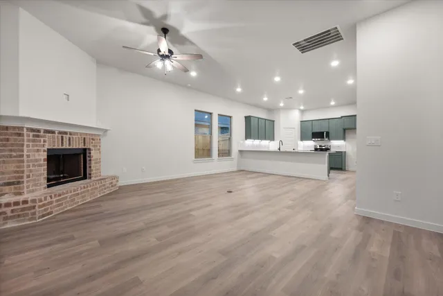 a view of a kitchen with a sink and a fireplace