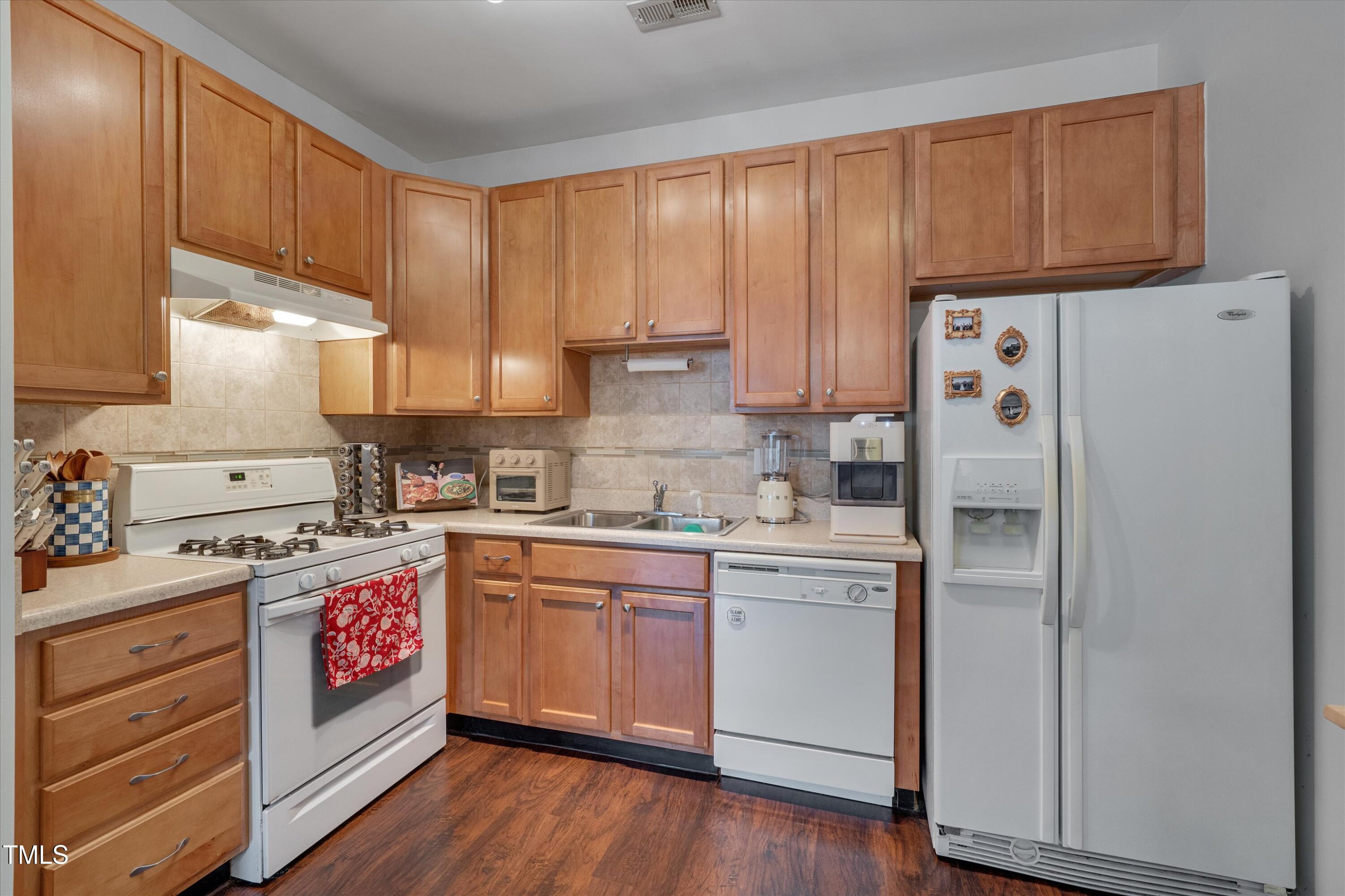 2210 Raven Road, Unit 106 Raleigh, NC 27614 - Photo 12 of 27 a kitchen with stainless steel appliances granite countertop a refrigerator a stove and a sink with cabinets