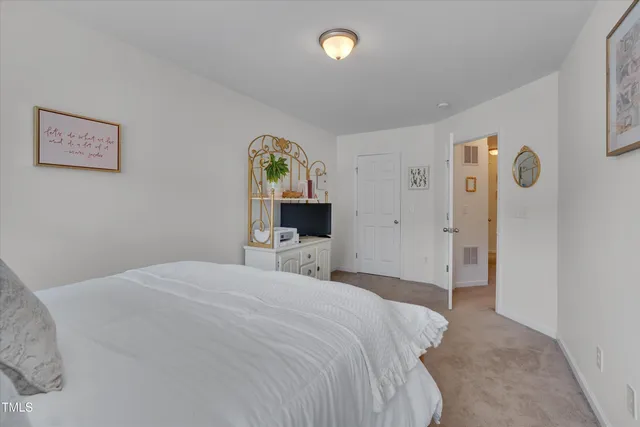 a bedroom with a bed and a table