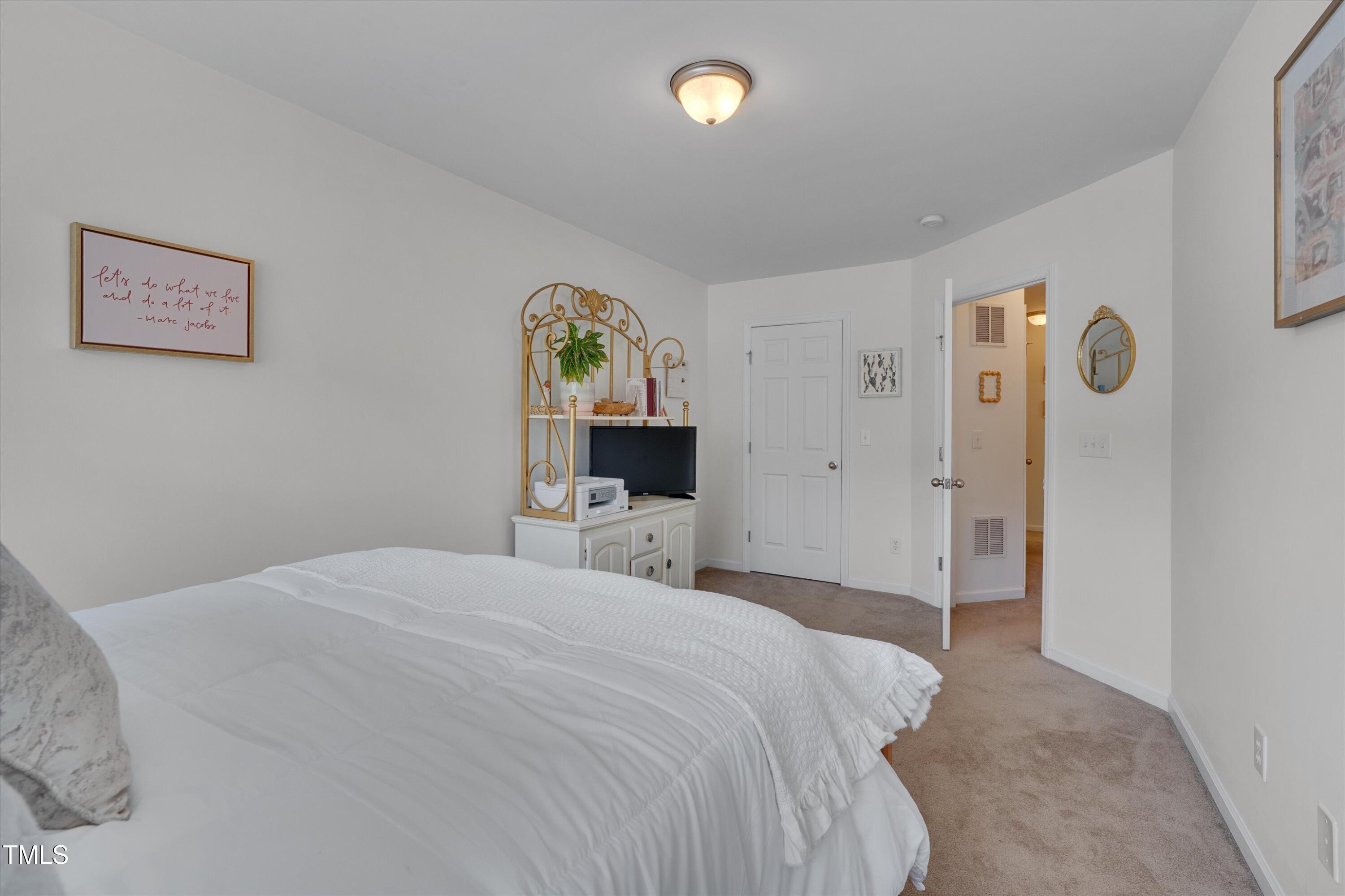 2210 Raven Road, Unit 106 Raleigh, NC 27614 - Photo 16 of 27 a bedroom with a bed and a table