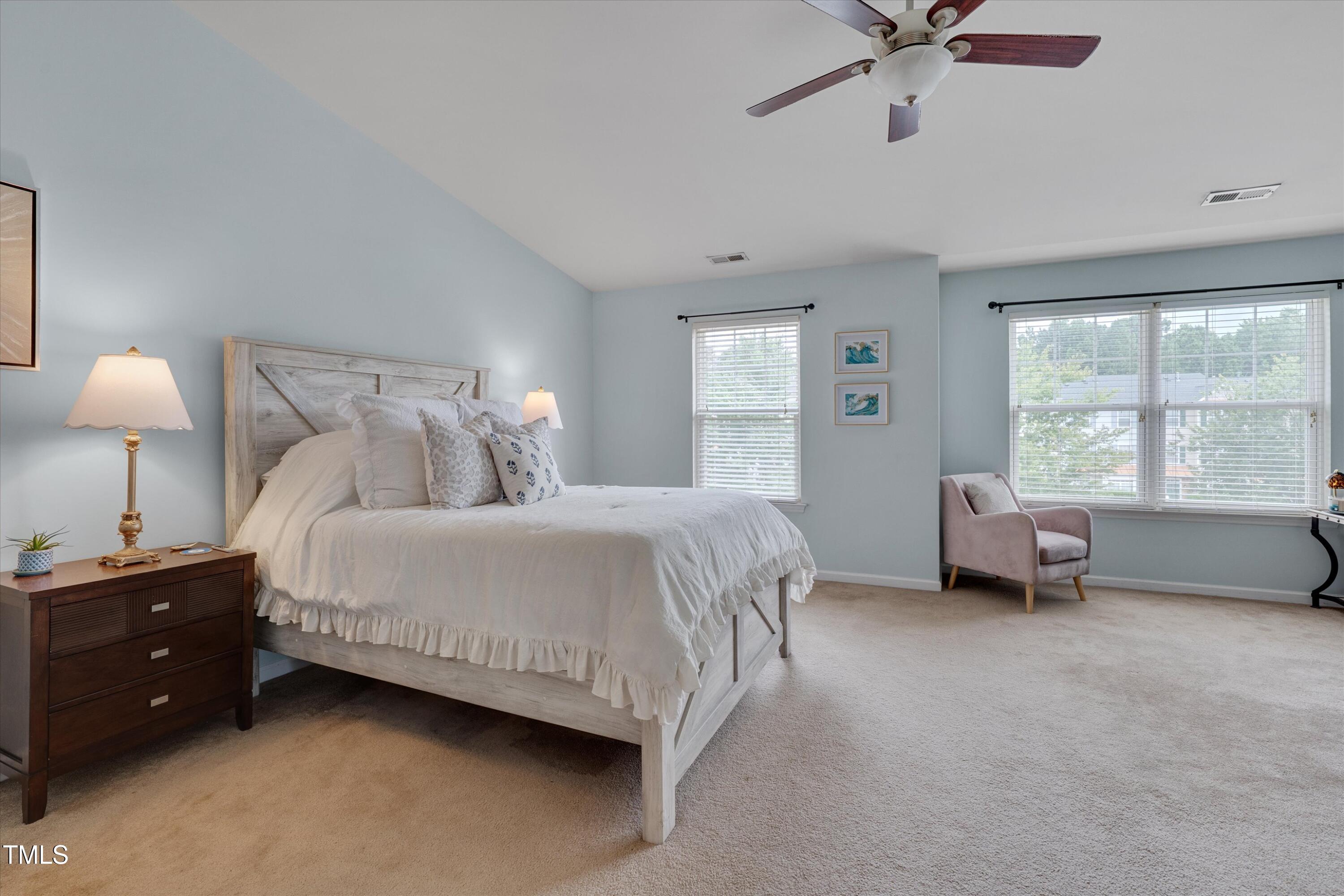 2210 Raven Road, Unit 106 Raleigh, NC 27614 - Photo 22 of 27 a spacious bedroom with a bed and a chandelier