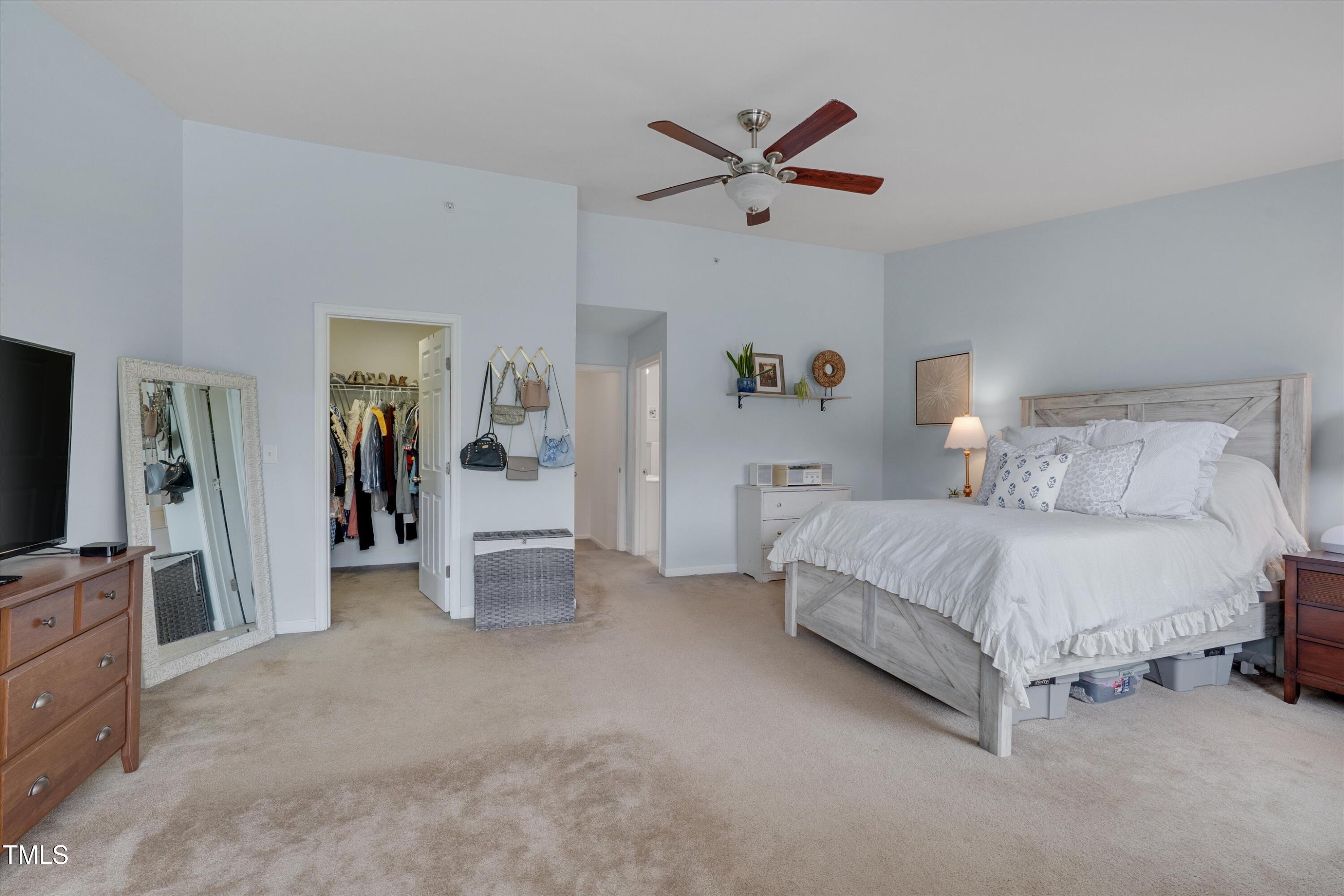 2210 Raven Road, Unit 106 Raleigh, NC 27614 - Photo 24 of 27 a spacious bedroom with a bed and a flat screen television