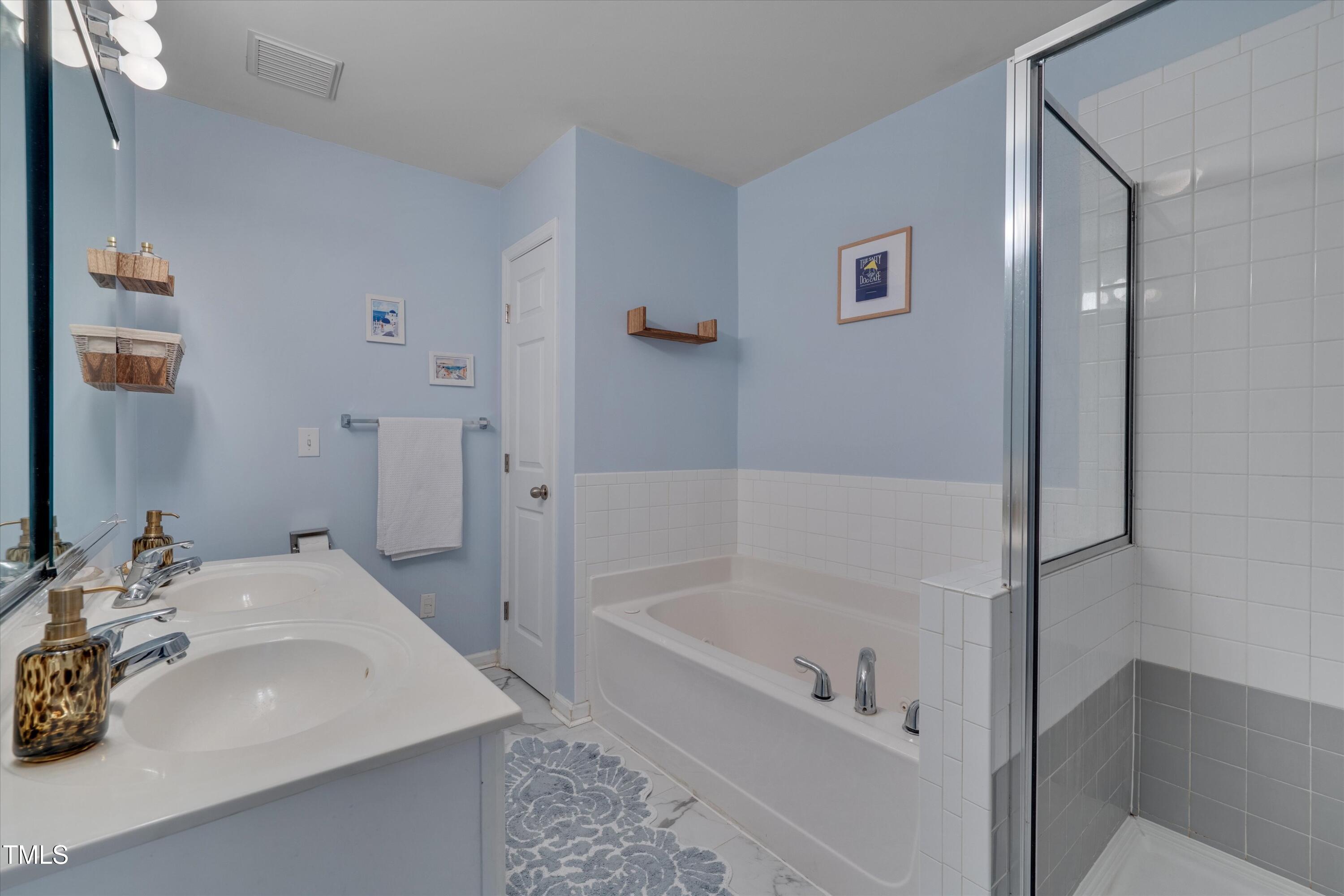 2210 Raven Road, Unit 106 Raleigh, NC 27614 - Photo 25 of 27 a white bath tub sitting next to a white sink