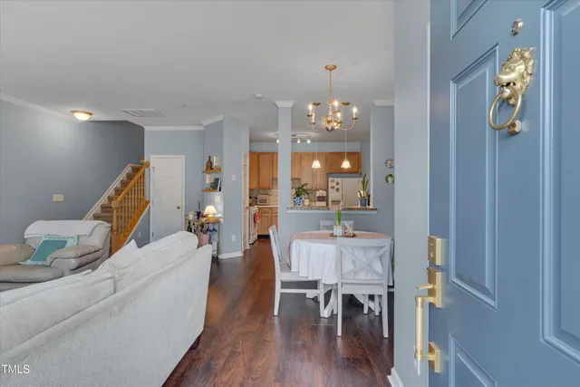 a view of front door of house with potted plants