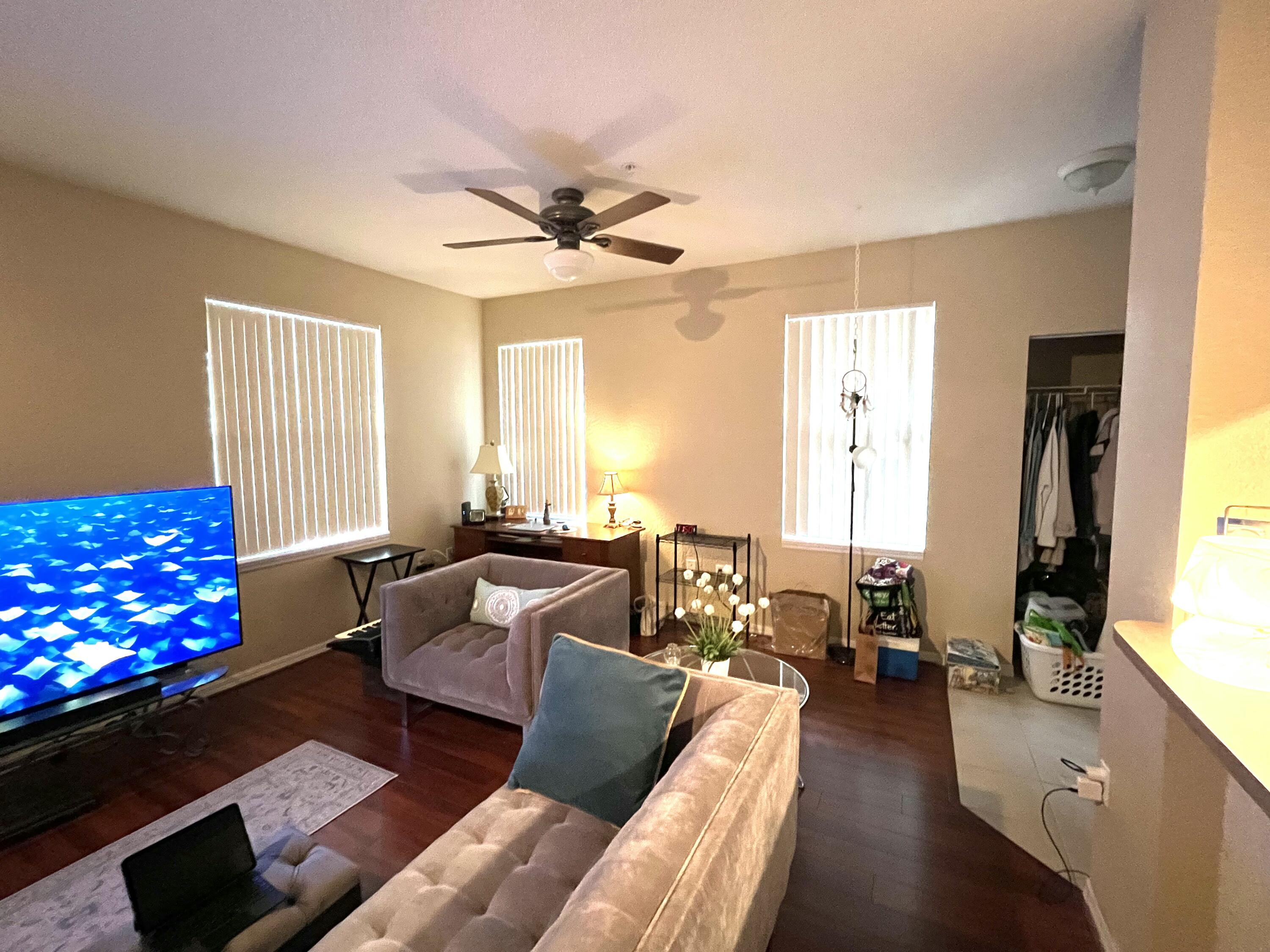 6890 West Sample Road, Unit 6890 Pompano Beach, FL 33063 - Photo 3 of 10 a living room with furniture fireplace and a window