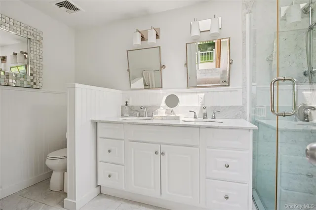 a bathroom with a granite countertop sink mirror and