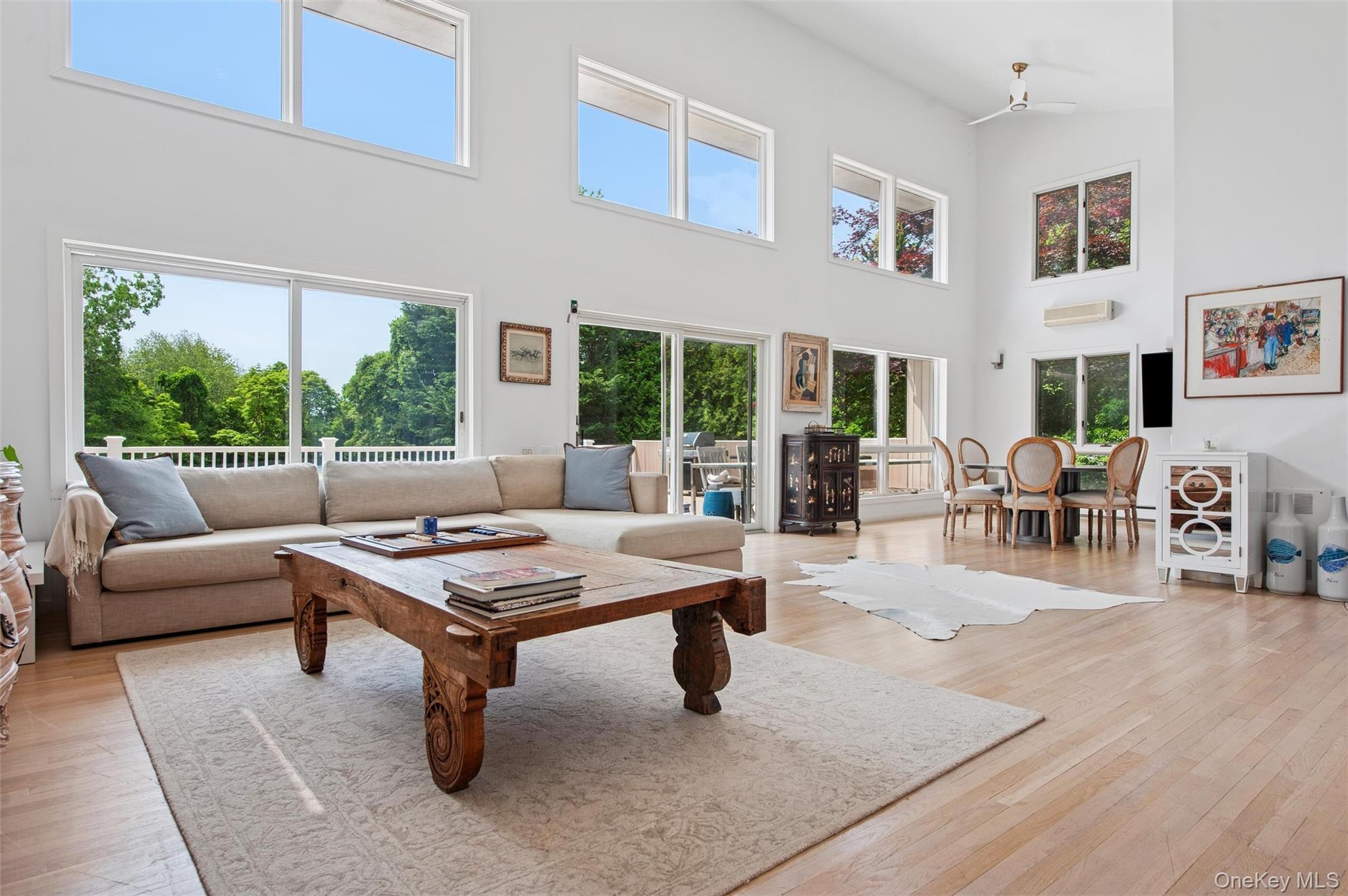 251 Sebonac Road Southampton, NY 11968 - Photo 3 of 15 a living room with furniture a table and a large window