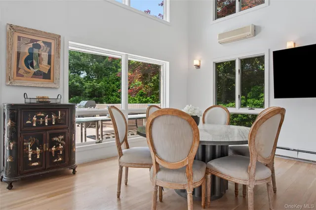 a view of a dining room with furniture window and wooden floor
