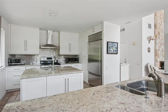a kitchen with a sink stove and refrigerator