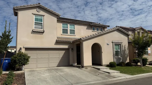 a front view of a house with garage
