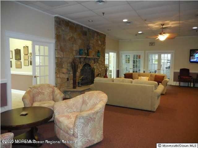 15 Markham Road Brick, NJ 08724 - Photo 20 of 28 a living room with furniture a fireplace and a chandelier