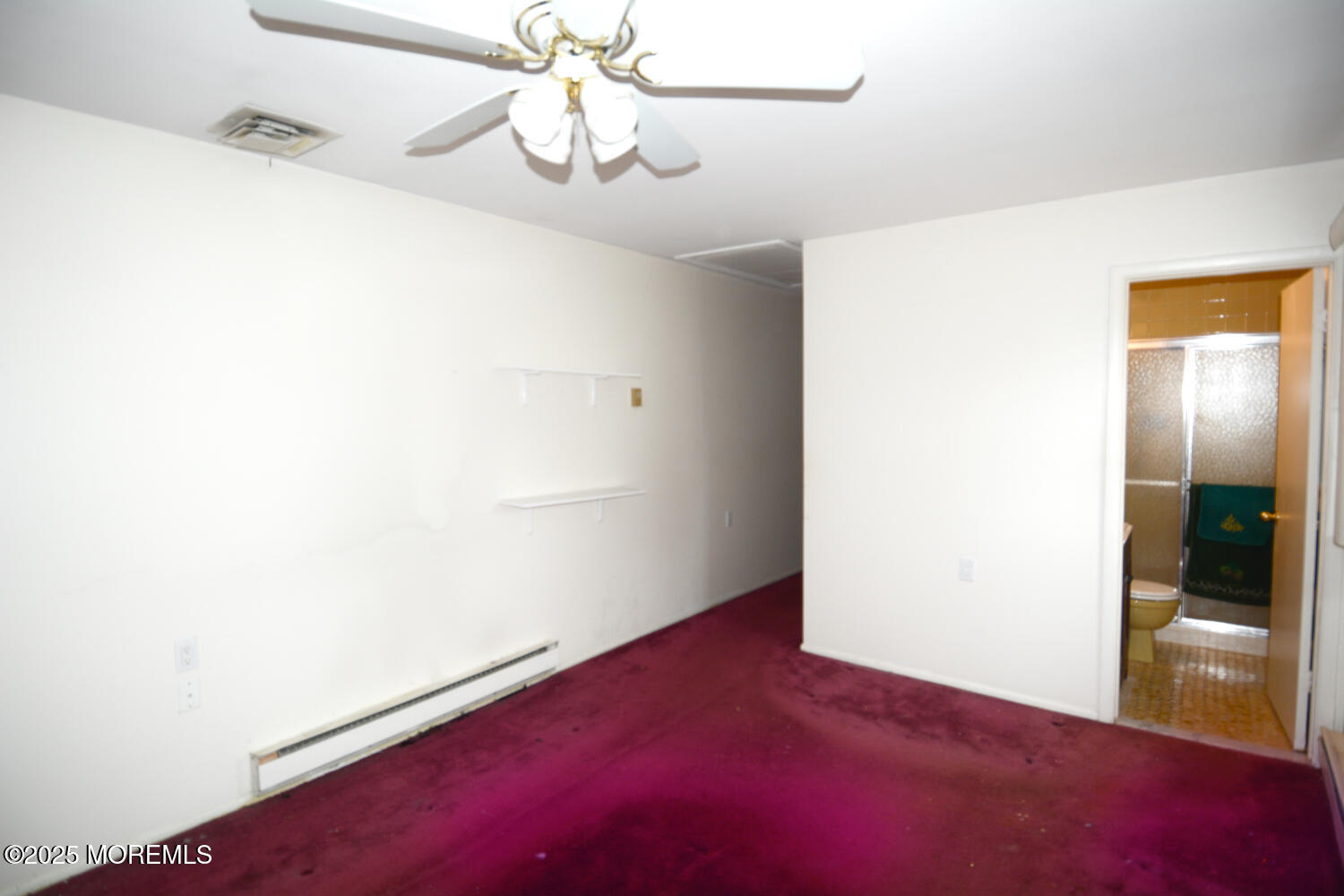 15 Markham Road Brick, NJ 08724 - Photo 10 of 28 an empty room with a chandelier fan and wooden floor