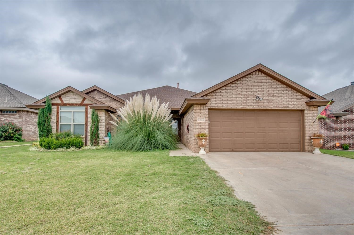 5518 104th Street Lubbock, TX 79424 - Photo 1 of 10 a view of a house with a yard and garage