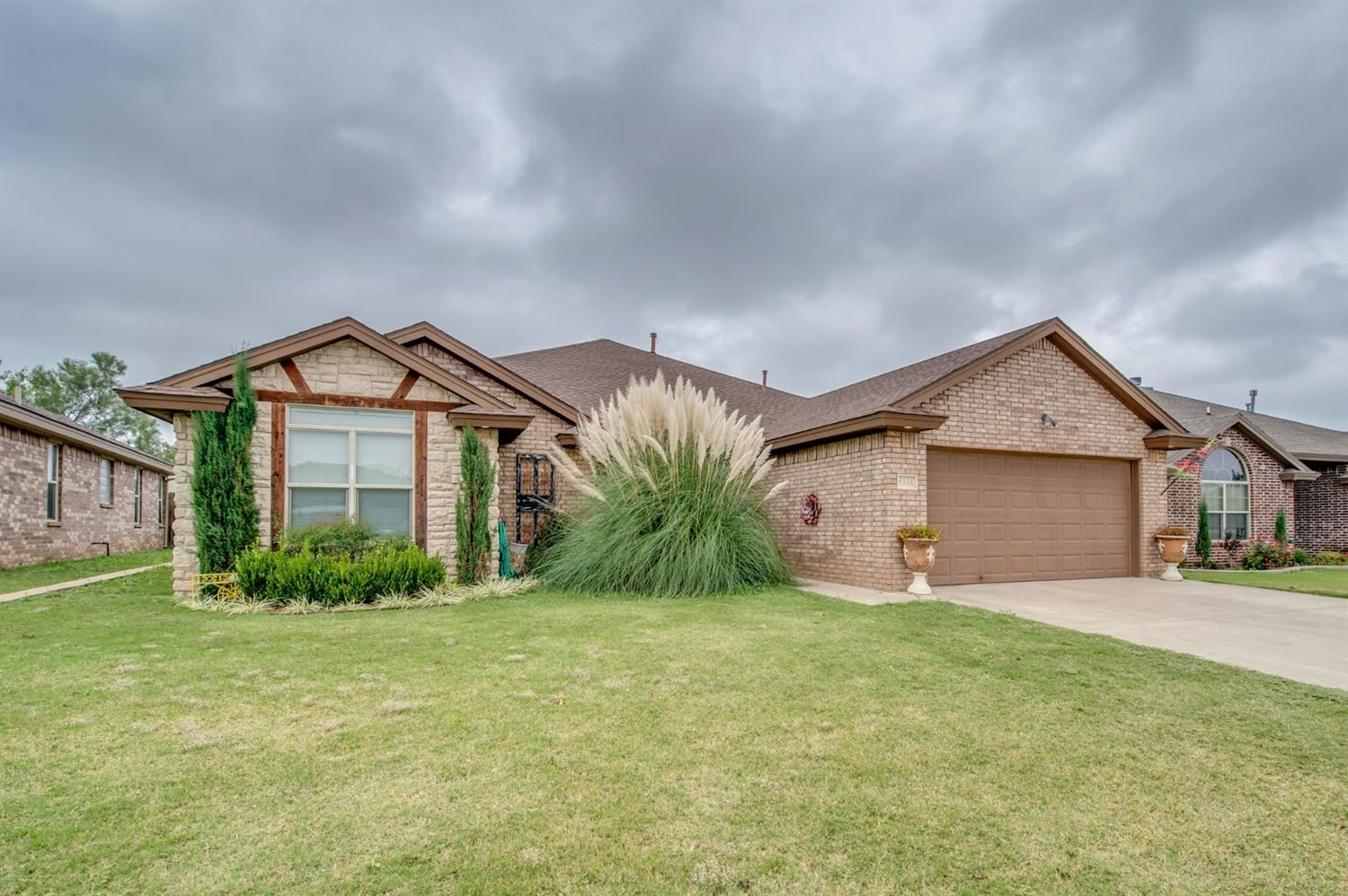 5518 104th Street Lubbock, TX 79424 - Photo 2 of 10 a view of a house with a yard and large tree