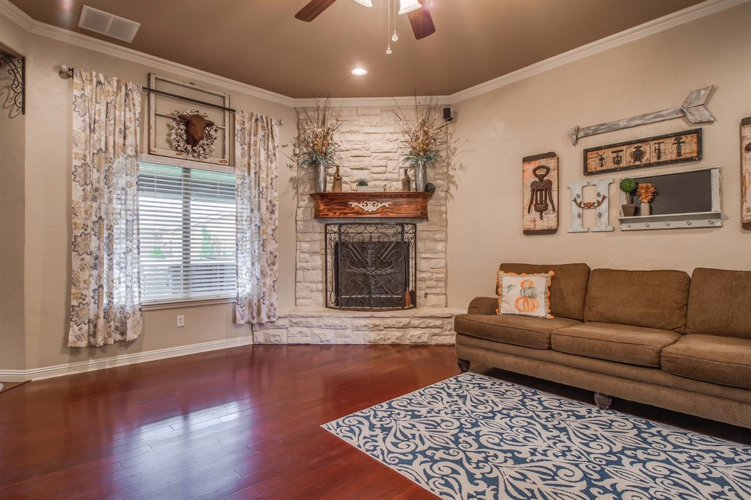 5518 104th Street Lubbock, TX 79424 - Photo 6 of 10 a living room with furniture and a fireplace