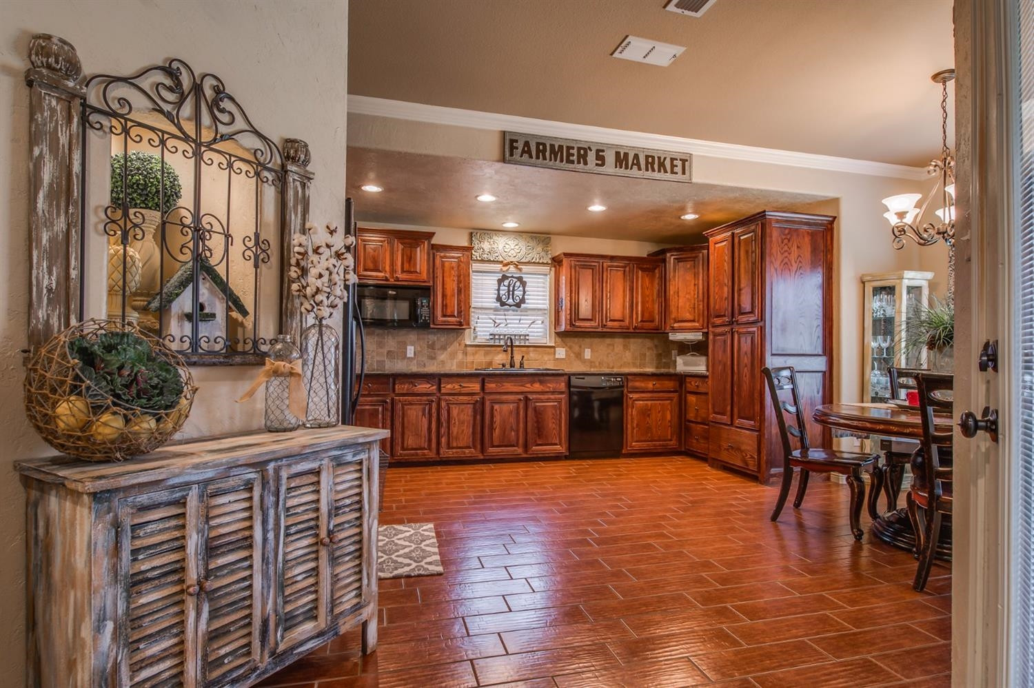 5518 104th Street Lubbock, TX 79424 - Photo 9 of 10 a kitchen with stainless steel appliances kitchen island granite countertop a table chairs and a refrigerator