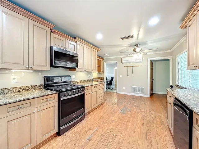 a view of a livingroom with furniture and a kitchen