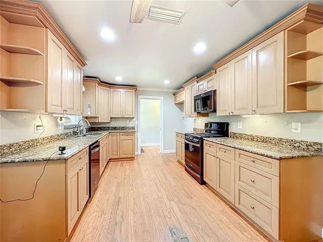 a view of an empty room with a ceiling fan and window