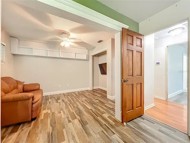 a view of empty room with wooden floor