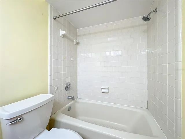 a kitchen with granite countertop a refrigerator oven a sink dishwasher and a stove top oven with wooden floor