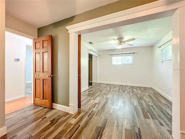a kitchen with stainless steel appliances a white stove top oven cabinets and a wooden floor