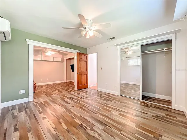 a view of a livingroom with a ceiling fan and window