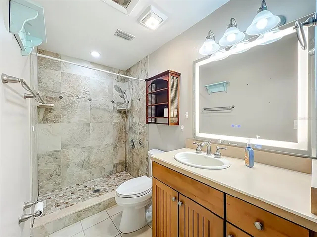 a view of a workspace with furniture and a ceiling fan