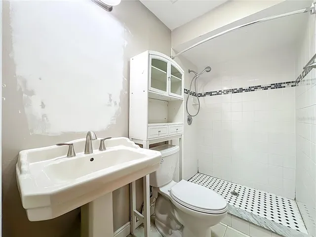 a view of a house with a yard and a tree